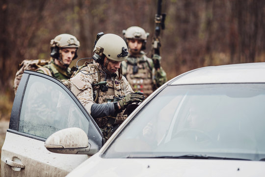 Soldiers At The Checkpoint Stopped A Car To Check Documents