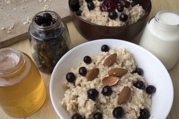 Delicious oatmeal porridge with berry and almonds for breakfast.