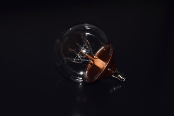 Light Bulb on Black Reflecting Background 
