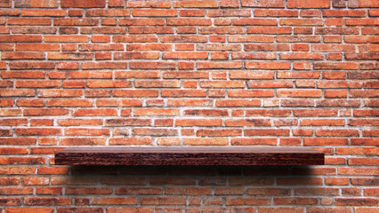Wooden shelf on the brick wall.