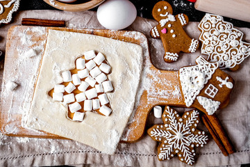 Fototapeta na wymiar cooking christmas gingerbread on wooden background top view