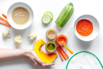 cooking vegetable puree for baby on white background top view