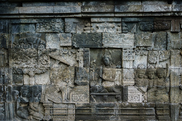 Carved relief at Borobudur on Java Indonesia. Borobudur is a Buddhist stupa and temple complex in Central Java and a UNESCO World Heritage Site.