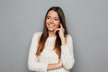 Portrait of a smiling girl in sweater laughing while standing