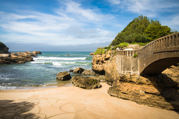 people enjoying in wonderful scenic atlantic seascape coastline by stone bridge, Biarritz, Basque...