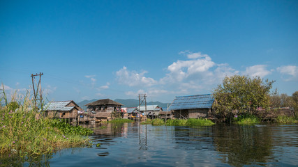 Fototapeta na wymiar The village on wooden piles of Intha people living over water at Inle lake, Shan state, Myanmar