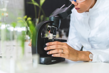 Scientist looking through a microscope