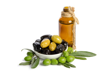 Black and green  olives  mixed in the  porcelain bowl and Virgin olive oil in a crystal bottle isolated on white background
