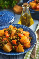 Vegetarian food - potatoes with pea and tomatoes, greek style cuisine.