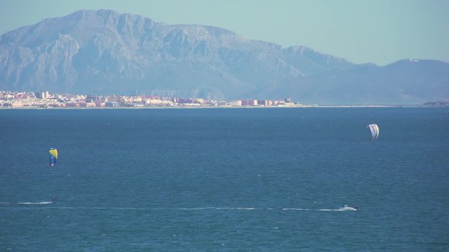 Kitesurfers surfing in the coast of spain near to africa