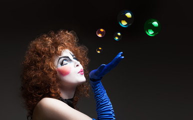 Woman mime with soap bubbles.