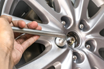 Men removing wheel for maintenance or repair image.