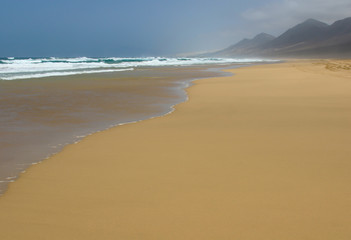 Ocean surf on magnificent Cofete beach in secluded part of Fuerteventura, Canary Islands, Spain