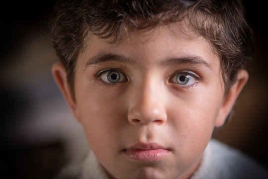 Close Viewing Portrait Of Cute Young Boy With Expressive Eyes