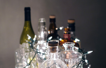 Obraz na płótnie Canvas Vintage clear glass liquor bottles with Christmas lights