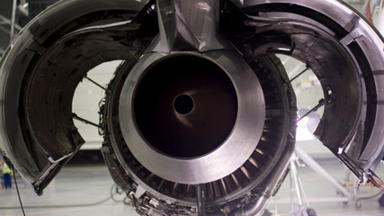 Fototapeta premium Engine of the airplane under heavy maintenance. Aircraft maintenance, dismantled plane engine. Chassis of the airplane under heavy maintenance