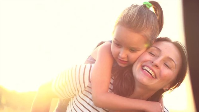 Happy mother with little girl enjoying nature together. Joyful family. Slow motion 4K UHD video 3840X2160
