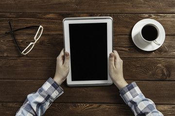 Tablet pc with blank screen in hands