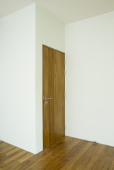 Empty room with wooden door