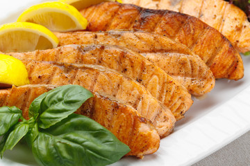 Closeup shot of grilled salmon on a white plate