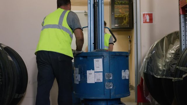 Workers load goods on a truck and taken to the warehouse. Employees Warehouse worker driver in uniform at storage warehouse. New cold room storage. Refrigeration and freezing warehouse
