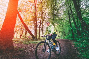 Fototapeta premium A man on a bicycle in the woods