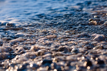 foaming seawater with pebbles