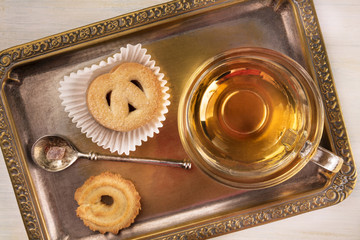 Danish butter cookies and cup of tea on vintage tray 