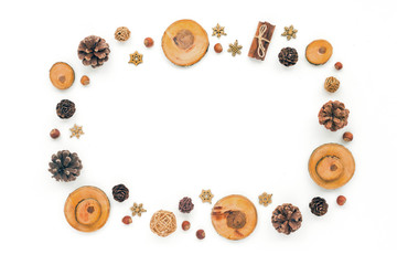 Christmas wood slice decorations, pine cone, spruce branches on white background, flat lay, top view, copy space