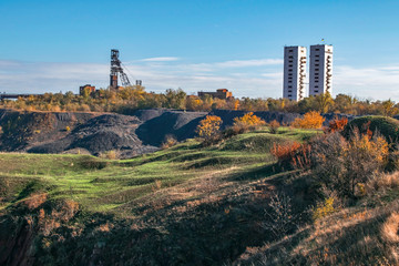 Landscape with two mine head frames . Ukraine, Kryvyi Rih, Iron-ore mine Gvardeiskaya. An autumn sunny day with blue sky