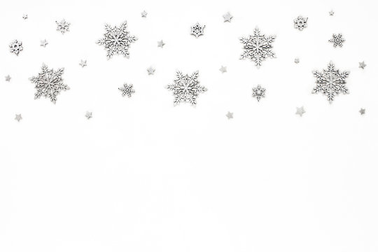 Silver christmas snowflake on white background, flat lay, top view, christmas pattern