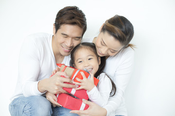 Attractive Asian family holding with each other. Kid received Gift with Attractive smiling. Kid with Happy Emotion.