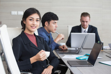 Asian Woman have a meeting with team for Business present. Woman working at meeting room with team. People working concept. 20-30 years old.
