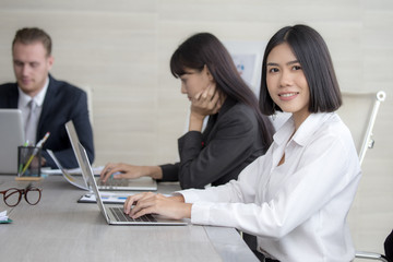 Fototapeta premium Asian Woman have a meeting with team for Business present. Woman working at meeting room with team. People working concept. 20-30 years old.