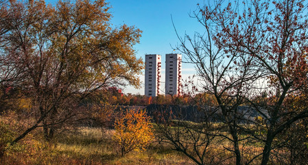 Landscape background with two mine head frames . Ukraine, Kryvyi Rih, Iron-ore mine Gvardeiskaya. An autumn sunny day with blue sky. Kryvbas