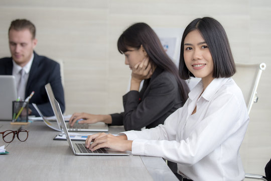 Asian Woman have a meeting with team for Business present. Woman working at meeting room with team. People working concept. 20-30 years old.