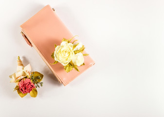 Bunches of flowers and pink purse.White isolate background.Flat lay, top view.space for text.universal template