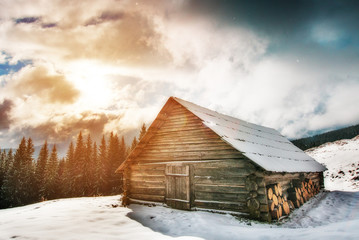 Dramatic view of a wooden house in winter