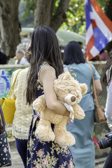 woman carrying a big bear.