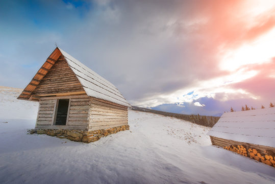 Dramatic view of a wooden house in winter
