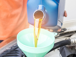Mechanic change engine oil to preserve engine life,  maintenance concept