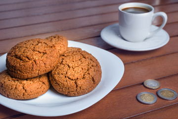 Coffee cup and cookie on wood