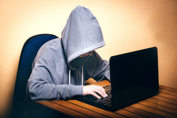 A hacker working on a laptop
