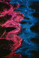 Multicolor abstract glitter background. Flowing waves. Red sand and blue water. Nature elements concept