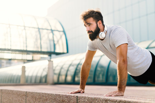 Handsome Man Doing Push Ups In Urban Area