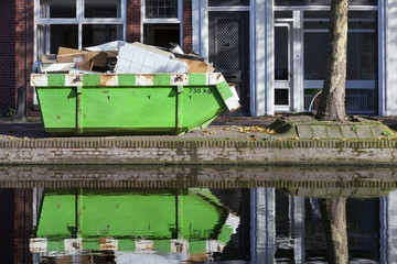 Builders skip near a canal in Gouda