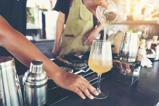 Barman at work, preparing cocktails. concept about service and beverages