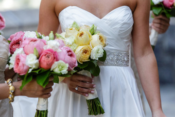 Bride bridesmaid holding wedding flower bouquet