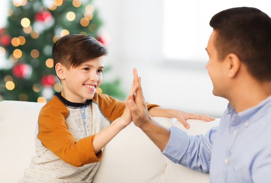 happy father and son doing high five at christmas