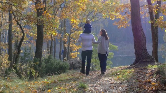 happy family walking in beautiful autumn park
